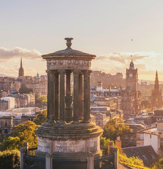 Die Skyline von Edinburgh erstreckt sich mit vielen Kirchen unter dem abendlichen Himmel.